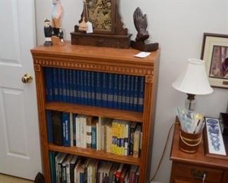 vintage clock, bookshelf, hardback/paperback books, figurines