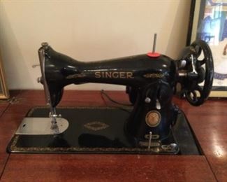 Vintage Singer sewing machine. It works. Includes cabinet, attachments, manual and sewing supplies