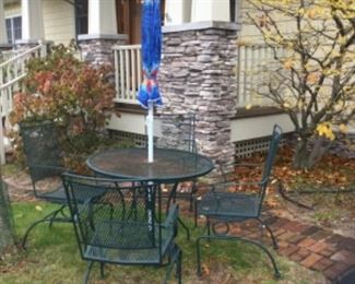 Vintage heavy-duty wrought iron patio table and 4 chairs 