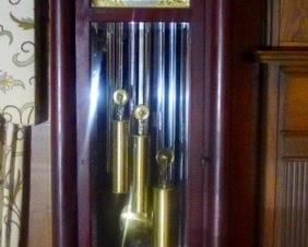 Very Nice TIFFANY Chiming Grandfather clock with Westminster, Whittington and St Michael chimes in original condition. Pillared Mahogany Case with Beveled Glass front and sides.