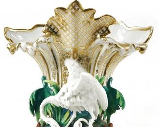 ANTIQUE SEVRES OLD PARIS ROCOCO PORCELAIN CRANE BIRD SNAKE FIGURAL VASE $550 plus shipping
 
Rare French porcelain figural vase depicting a crane or stork eating a wriggling snake.  It dates between 1870 - 1890 and is a fine display with gold gilt decoration and colorful leaves with red vines at the base.  A very unusual and rare French porcelain piece!
 
"Old Paris" is a loose term, denoting a production time frame from the late 18th century up to the 1870s. Larger factories may have signed their wares, or produced blanks for other, smaller shops to paint, but many pieces were unmarked.
 
DETAILS:
 9" Tall x 10" wide
 
Condition:  In very good condition with some gilt loss and one palm leaf has three broken leaves.   Wear consistent with age and use. Insignificant broken leaf. (see photo). Some wear to gold gilt trim typical to age. Minor kiln cracking. 