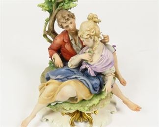 CAPODIMONTE PORCELAIN G CAPPE MAN LADY LOVERS GROUP ITALIAN FIGURINE $300 plus shipping
 
 
DETAILS:
 Giuseppe Cappe Porcelain Figurine
 Outdoor Scenic Depiction of a Couple in Love
 Made In Italy
 Measurements: ~7.5" tall x 7 1/4" wide
 
Condition:  Vintage. Small chip behind leaves and the underside of base.