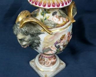ANTIQUE PORCELAIN CAPODIMONTE ITALIAN DECORATIVE VASE URN CHERUB RAM GOAT 7" H  $170 plus shipping
 
 
DETAILS:
Antique (1771 - 1834)
Porcelain Capodimonte 
Italy 
Decorative Vase / Urn 
Cherub with ram and goat head handle 
Allegorical Scenes of Cherubs
Different Scenes on Each Side
Rams Head with Gilt Horns as Handles 
Measurement: 5.5" (across handles) x 7" H on 2.25 x 2.25" Base 
 
Condition:  Decorative urn is in very good overall physical condition. No noticeable chips or cracks. Minor dust accumulated in crevices. Minor scuffs on base from being displayed.