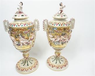ANTIQUE SET OF 2 CAPODIMONTE 13" H LIDDED URN TANKARDS CHERUB AT PLAY WITH FIGURAL FINIAL $605 plus shipping
 
 
DETAILS:
Antique (1771 - 1834)
Porcelain Capodimonte 
Italy 
Decorative Vase / Urn / Tankard 
Lidded
Figural Finial 
Cherub at Play 
Allegorical Scenes of Cherubs
Different Scenes on Each Side
Frieze of Classic Gold Gilded Accent Patterns Throughout 
Measurement: 15" (across handles) x 13" H 
 
Condition:  Very good antique condition.  