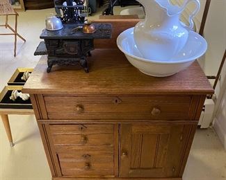 Washstand; pitcher and basin set; Crescent cast iron stove with pots/pans/accessories.