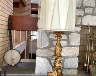 $100                                                                                                           VINTAGE ROMANTIC VERY TALL CARVED WOOD AND GOLD GILDED ITALIAN STYLE TABLE LAMP
Impressively tall and romantically distressed antique ornately carved wooden pricket lamp having gorgeous carving throughout and standing on a three legged base.  The shade is a custom silk vintage piece.
DETAILS + DIMENSIONS:
OVERALL 15"W X 15"D X 44"H
SHADE - 15"W X 15"D X 17"H
CONDITION: The shade has minor staining. The body of the lamp is in good condition.  This is a vintage piece and has signs of wear to be expected with age and use.  Please refer to photo's for a more detailed look at condition.  We make every attempt to list and photograph any defects or signs of wear that are significant to this sale. 
LOCAL PICK UP BUYER BOYDS, MD. BUYER IS RESPONSIBLE FOR ANY NECESSARY DISASSEMBLY AND ALL COSTS ASSOCIATED WITH SHIPPING OR PICK UP.  