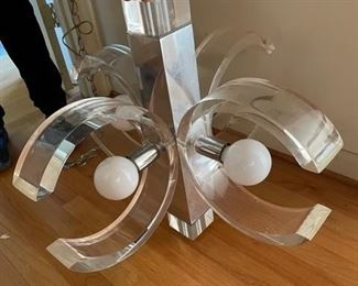 $200                                                                                                               MID CENTURY CHROME AND LUCITE CHANDELIER IN THE STYLE OF CHANEL
**OFFERS CONSIDERED
Stylish mid century Lucite chandelier. 4 Lucite "C"s reminiscent of the infamous Chanel logo encase each of the 4 white globe bulbs (1 bulb is missing). This central rectangular Lucite base is encased in chrome for added sparkle and classic mid century style.
DETAILS + DIMENSIONS:
24"W X 24"W X 20"H
CONDITION: This piece has been well cared for and are in very good condition. Please refer to photo's for a more detailed look at condition.  We make every attempt to list and photograph any defects or signs of wear that are significant to this sale. 
LOCAL PICK UP BOYDS, MD. (PIECE IS ON THE FIRST FLOOR WITH EASY ACCESS)  BUYER IS RESPONSIBLE FOR ANY NECESSARY DISASSEMBLY AND ALL COSTS ASSOCIATED WITH SHIPPING OR PICK UP.                  
