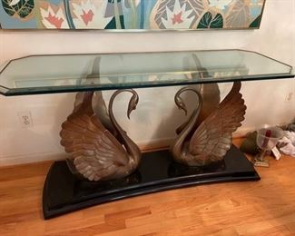 $1000                                                                                                       HOLLYWOOD REGENCY STYLE ITALIAN DOUBLE BRASS SWAN CONSOLE TABLE WITH GLASS TOP - ALL OFFERS CONSIDERED
DETAILS + DIMENSIONS:
This is a mid century solid brass Console table is in the Hollywood Regency style. Made in America, circa 1975, this elegant piece makes a statement with it's two dynamic swans facing each other topped by a thick glass top.
THIS IS PART OF A 4 PIECE BERNHARDT "SCENE THREE DINING COLLECTION" THAT WE ARE SELLING. PLEASE CONTACT US FOR INFORMATION ON THE OTHER AVAILABLE PIECES.
59" L X 22" D X 31"H
CONDITION: This piece has been treasured and is in very good condition. Please refer to photo's for a more detailed look at condition.  We make every attempt to list and photograph any defects or signs of wear that are significant to this sale. 
LOCAL PICK UP BOYDS, MD. (PIECE IS ON THE FIRST FLOOR WITH EASY ACCESS)  BUYER IS RESPONSIBLE FOR ANY 