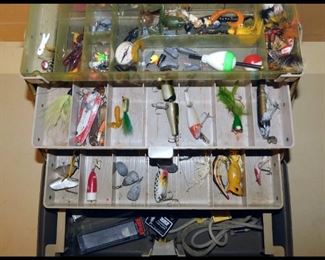 Fishing tackle box with lures and other fishing items.