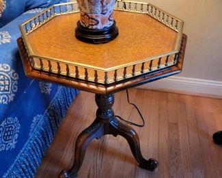 Octagonal table with raised brass column edge. 29" high x 21" wide.