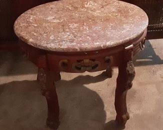 Oval Victoria side table with carved wood base.