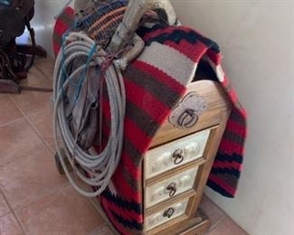 A saddle, saddlebags and saddle stand