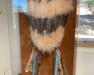 Native American headdress in lucite case