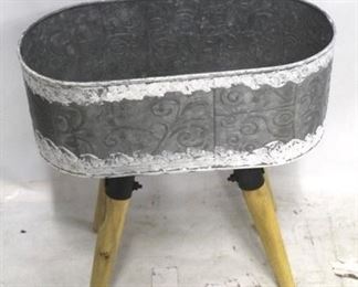 1372 - Oval metal planter on wood legs 16 1/2 x 17 x 10