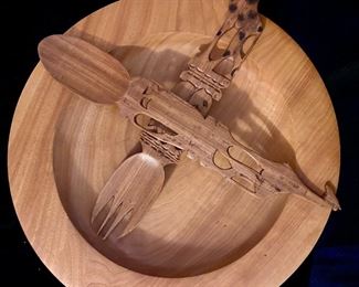 Carved wooden salad bowl with fork and spoon