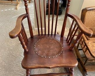 Antique rocker with leather detailed seat