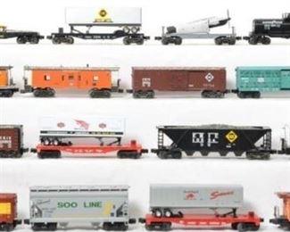 CURRENT OFFER: $200   LOT 20: 16 Lionel and K Line freight cars. 
Description: Sixteen cars include 19255 Erie boxcar, 19324 Erie hopper, 7200 Erie flat with trailer, modern 6411 flat with Beechcraft bonanza, 26795 New York Central stock carwith sounds, 19604 Goodyear tank car, 16565 Milwaukee Road caboose, 19254 Erie boxcar, 36557 Rio Grande work caboose, 19720 Soo Line caboose, 17006 Soo Line hopper, 9823 flat with Prowler, 25077 Milwaukee Road caboose, 1905-05 New York Central flat with Red Wing Shoe trailer, and K Line Milwaukee Road bay window caboose. Cars are generally C7-8 with dust from display.