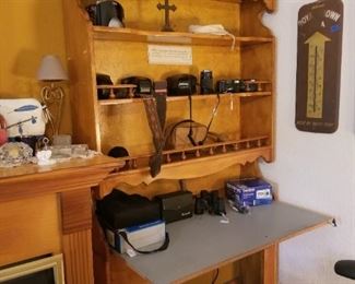 Desk with shelves, vintage cameras, binoculars, vintage thermometer