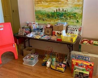 Kids corner:   Curious George, box of craft supplies, box of strawberry shortcake, foam connector squares, easel, miscellaneous kids toys.