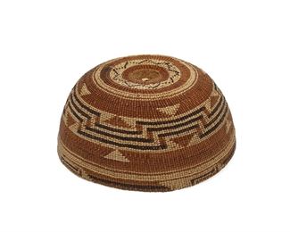 5005
A Hupa/Kurok Basketry Hat
First-Quarter 20th Century
The twined basket with a banded geometric motif throughout
3" H x 6.75" Dia.
Estimate: $600 - $800