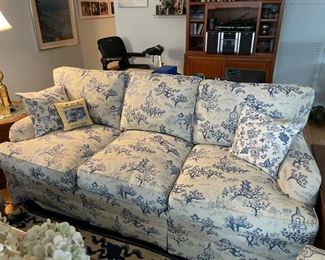 Sherrill Sofa Upholstered in Blue Toile Fabric. Measures 73" W x 38" D. Front & Cushions are in EXCELLENT condition but cat did scratch the top of the frame. Only noticeable if sofa is floating in a room. Photo 1 of 4.