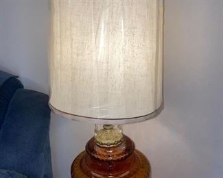 Pair of Vintage Amber Glass Lamps
Like new condition! 
These are HUGE!
Lampshades still have plastic on them. 
There is a small light inside the lamp base that turns on as well as the regular lamp.
39” tall x 15” across.