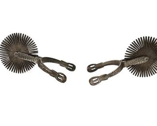 6044
A Pair Of Chilean Huaso Spurs
First-Quarter 20th Century
Appears unmarked
The silvered metal spurs with large rowels and chased designs to the shank and heelband, 2 pieces
Each: 4.25" H x 3.5" W x 8.25" D approx.
Estimate: $200 - $300

