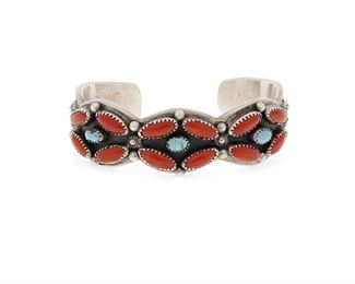 6104
A Navajo Silver And Coral Cuff Bracelet
Fourth-Quarter 20th Century or Later, Diné
Stamped: Mary Matt / conjoined AT [shop mark for Atkinson Trading Co]
A narrow coral and turquoise cluster set cuff bracelet with stamped terminals
6.5" total inner C x 0.875" H, wrist opening: 1"
80.4 grams
Estimate: $300 - $500