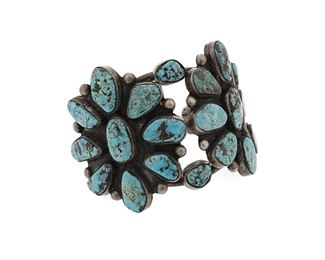 6109
A Large Silver And Turquoise Cluster Bracelet
Second-Half 20th Century
Appears unmarked
A three wire cuff with two starburst cluster plaques of sawtooth bezel-set turquoise
6.75" total inner C x 2.5" W, wrist opening: 1.125"
105.0 grams
Estimate: $400 - $600