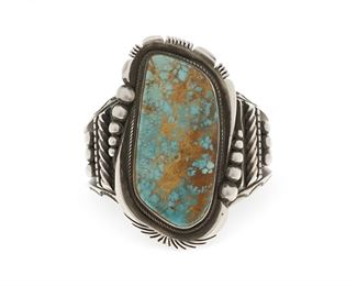 6113
A Large Ernest T. Bilagody Sr. Navajo Silver And Turquoise Cuff Bracelet
Second-Half 20th Century, Diné
Stamped: E. Bilagody / Sterling
A large Royston turquoise stone set to a heavy cast plaque with an elaborate cuff
6.5" total inner C x 3" H, wrist opening: 1.125"
166.1 grams
Estimate: $300 - $500