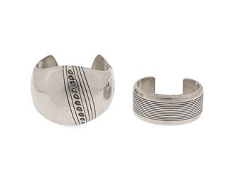 6119
Two Southwest Navajo Silver Cuff Bracelets
Fourth-Quarter 20th Century, Diné
Two works:

An Orville Tsinnie Navajo cuff bracelet
A Modernist style domed silver cuff with offset stamped motif to center and terminals
Stamped: Orville Tsinnie of New Mexico / [Adobe pictographs] / Sterling
7" total inner C x 2.25" H, wrist opening: 1"

A Dan A. Jackson Navajo silver cuff bracelet
A silver cuff designed with ribbed silver central lines
Stamped: D.A. Jackson / [artist's hogan cypher]
6.25" total inner C x 1.125" H, wrist opening: 1"

2 pieces
210.8 grams gross
Estimate: $300 - $500
