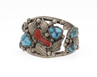 6120
A Southwest-Style Cuff Bracelet
Mid-20th Century or Earlier
Etched: EUZR [possibly old pawn marking]
Set with branch coral and turquoise nuggets with silver leaf motif on a two-wire cuff
6.625" total inner C x 2" W, wrist opening: 1.25"
86.6 grams gross
Estimate: $200 - $400