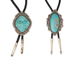 6133
Two Large Silver And Turquoise Bolo Ties
Mid-20th Century
Each stamped: TT [possibly for Tom Taylor, Navajo/Diné] / Sterling
Comprising a large diamond-shaped silver and turquoise bolo with cylindrical silver tips all suspended from a black braided leather cord (bolo: 3.625" H x 3" W) and a large oval silver and turquoise bolo with tapered silver tips all suspended from a black braided leather cord (bolo: 4" H x 2.75" W), 2 pieces
365.5 grams gross
Estimate: $400 - $600