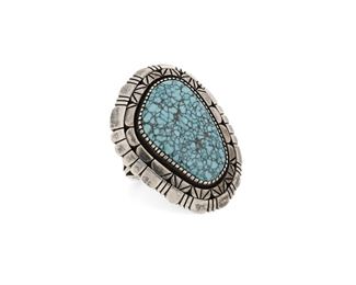 6146
A Navajo Turquoise And Silver Ring
Fourth-Quarter 20th Century, Diné
Stamped: B [possibly Billy Slim]
A shadowbox bezel set stone with heavy matrix, surrounded by elaborate stampwork and filework edges, on a split wire band
Ring size: 10.25
30.3 grams
Estimate: $200 - $400