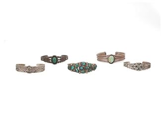 6168
Five Southwest Silver Bracelets
20th Century
Each appears unmarked
Comprising a Fred Harvey-style green turquoise-set cuff with bird elements (6" total inner C x 0.75" W), a Fred Harvey-style turquoise-set cuff with arrow elements (6" total inner C x 0.75" W), a Fred Harvey-style cuff topped with single eagle element (6" total inner C x 0.75" W), a two wire cuff bracelet topped with vari-shaped turquoise (6" total inner C x 1" W), and a twisted wire cuff topped with a single turquoise (5.75" total inner C x 0.625" W), 5 pieces
94 grams gross
Estimate: $200 - $300