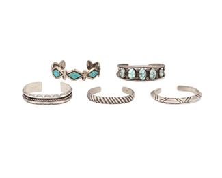 6169
Five Southwest Silver Cuff Bracelets
Mid-20th Century
Each unmarked
Comprising a two wire cuff topped with five oval-shaped turquoise (6.5" total inner C x 0.75" W, wrist opening: 1"), a cuff set with five kite-shaped turquoise (6" total inner C x 0.5" W, wrist opening: 1.125"), a stamped cuff centering twisted wire (6.25" total inner C x 0.5" W, wrist opening: 0.875"), a knife edge cuff with criss-cross stamps (6" total inner C x 0.25" W, wrist opening: 0.875"), and a diagonal fluted cuff (6" total inner C x 0.25" W, wrist opening: 1")

5 pieces
152.8 grams gross
Estimate: $500 - $700