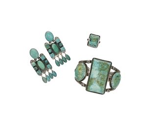 6179
A Group Of Southwest Jewelry
Fourth-Quarter 20th Century or Later
Three works:

A stamped three wire cuff topped by three bezel set turquoise slabs within a twisted wire frame
Appears unmarked
6.125" total inner C x 2" H, wrist opening: 1"

A rectangular bezel set turquoise ring with purple stone accents
Signed with an etched M Y or L; further stamped: Sterling / 925
Ring size: 5

A pair of Navajo turquoise set earrings with stampwork accents and turquoise dangles
Stamped: conjoined JFT [for Jeanne and Felix Tsinijinnie, Diné]
2.25" L x 1" W

4 pieces
139.4 grams gross
Estimate: $300 - $500