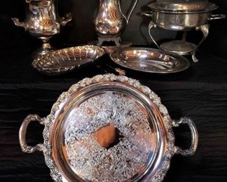 https://ctbids.com/estate-sale/13112/item/1131396 Serving in Style: Gorgeous Silverplated Pieces
Beautiful silverplated serving pieces that will allow you to entertain in style. Largest tray measures 19.5" wide including handles. The large tray has an inscription on the back. (Dark reflection is from wooden ceiling.) The silver layer has peeled off of the base of the pitcher (the feet). It actually gives it some contrast, character, and charm. 