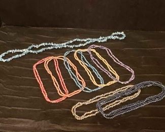 https://ctbids.com/estate-sale/13112/item/1131739 Stone And Ghost Bead Necklaces
These beaded necklaces are made of colorful rounded stones. The two bottom necklaces are lighter weight and are probably made of ghost beads (dried berries). The top necklace is made of stone pieces, as well. 