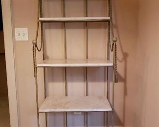 https://ctbids.com/estate-sale/13112/item/1187496 Baker's Rack W/ Marble Shelving
This beautiful baker's rack has five marble shelves. This is a very heavy piece. Decorative metal rope intertwined around the top. Parts of the rope may be some other material as one of the tassels has broken off. Please see photos fir this piece. The rack measures approximately 26.6" wide, 12" deep, and 68" tall.