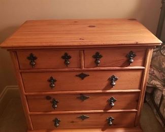 https://ctbids.com/estate-sale/13112/item/1188646 17th Century English Style Chest
"17th century English styling influences design of this five-drawer chest. Details include authentic pendant pulls. rounded rails and stiles, framed top, base molding, and turned feet. In pine solids and veneers." Measures 29.25" wide, 17" deep, and 27.5" in height.