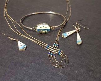 https://ctbids.com/estate-sale/13112/item/1216619 Sterling silver triple-strand necklace with beaded detailing and a silver bracelet and earring set with nature inspired detailing made in Mexico. Single earring could easily be adapted into a matching pendant. Necklace weighs approximately 5 grams.
