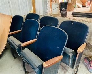 One of two sets of theater seating, the other is wooden.