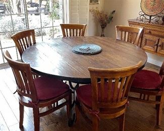 Large round table 60” - has iron base I think with 7 chairs 