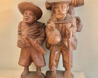 Carved wood.  Left: Man with bottle 7.5" H. Right: Man hiking 8" H. 