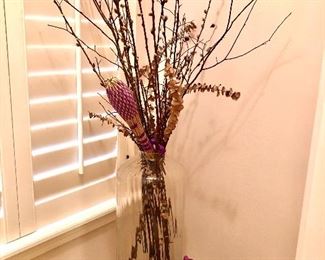 Tall glass vase with branches