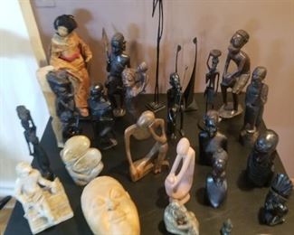 Collection of carved wood and stone people