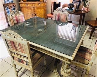 Antique Polish table with four chairs and custom tinted glass top.