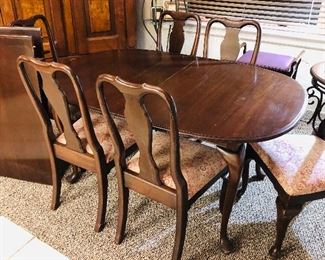 Dining room set with two inserts and six chairs.