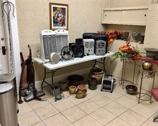 Large selection of space heaters, fans, trashcans, flower pots, artwork, plant stands.